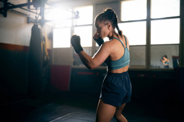 istock Young female kickboxer, shadowboxing during an practice in the gym 2171113648