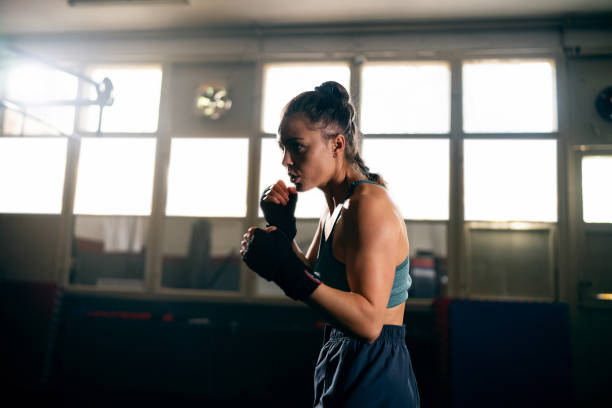 istock Female kickboxer, shadowboxing during an practice in the gym 2171113695