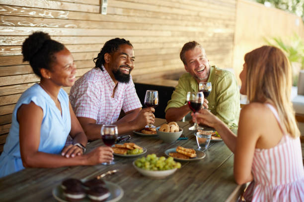 istock Happy diverse friends talking while drinking wine on a patio. 2171114303