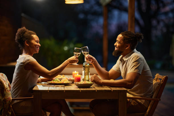 istock Happy black couple toasting during dinner on a patio. 2171114673