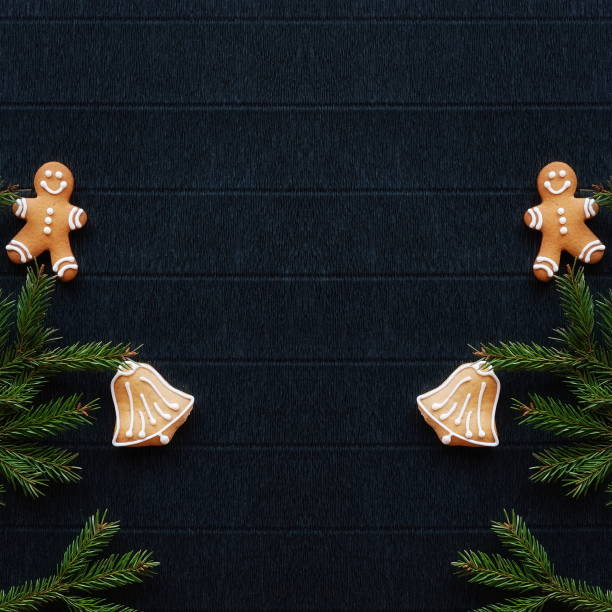 istock Gingerbread and Christmas tree branches on a dark paper craft background. Happy New Year Banner 2171119528