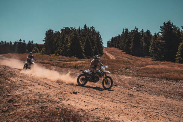 istock A motocross rider's adventure on a sunlit trail through the forest 2171119592