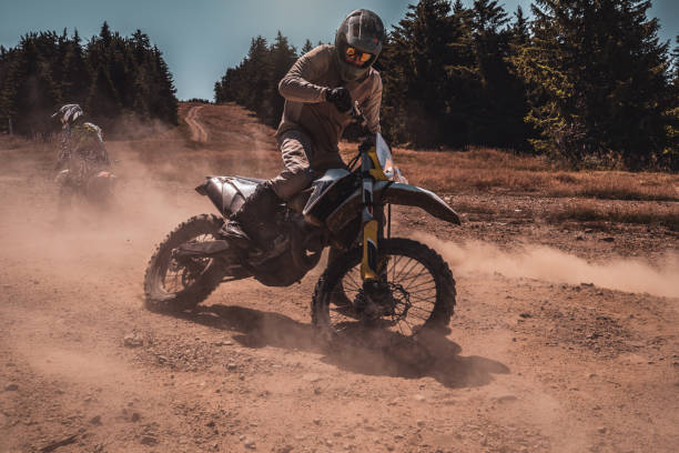 istock A motocross rider's adventure on a sunlit trail through the forest 2171119595