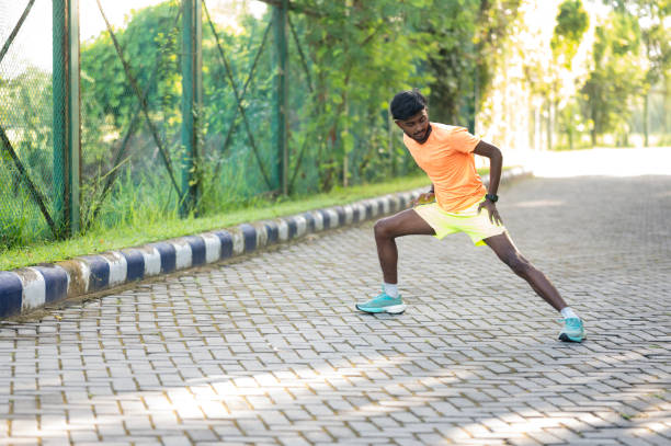 istock Young Athlete Performing a Stretching Exercise in a Park 2171119667