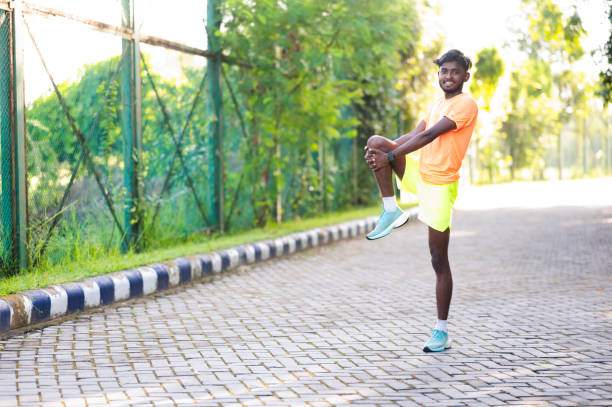 istock Fit runner doing warmup exercises in nature 2171119683