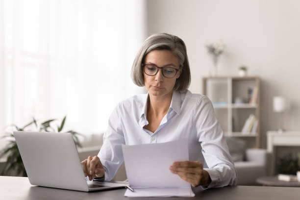 istock Serious woman consider financial report working remotely from home 2171122954
