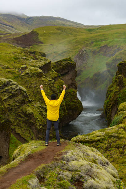 istock Man celebrating on a scenic mountain trail in Iceland 2171126560