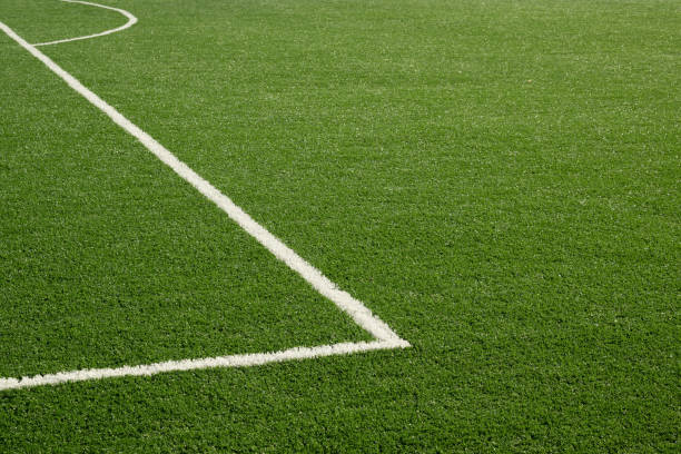 istock Painted white lines on soccer field with artificial green grass. 2171127397