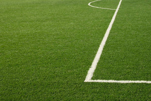istock Artificial green grass with white stripe of soccer field. 2171127406