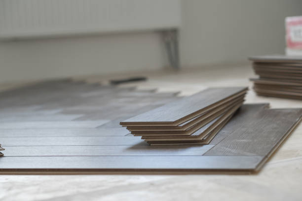 istock Handyman installing laminate flooring in a residential apartment. Step-by-step 2171129045