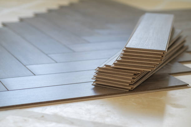 istock Worker installing laminate flooring in a residential apartment. Tools, planks 2171129219