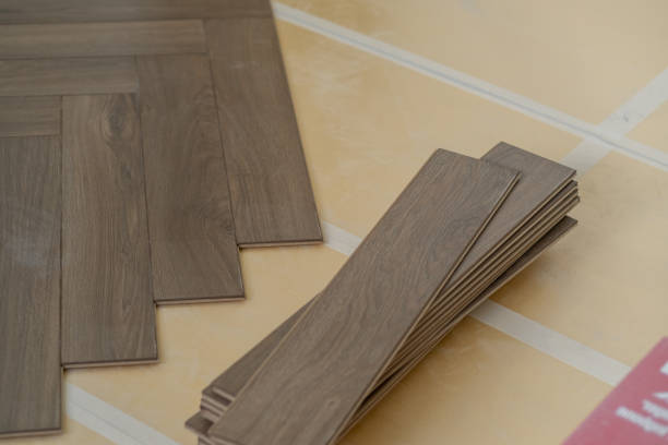 istock Laminate floor installation in a modern apartment, showing tools, planks 2171129259