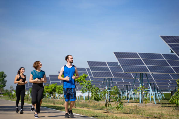 istock People are exercising near solar powerplant. 2171131894