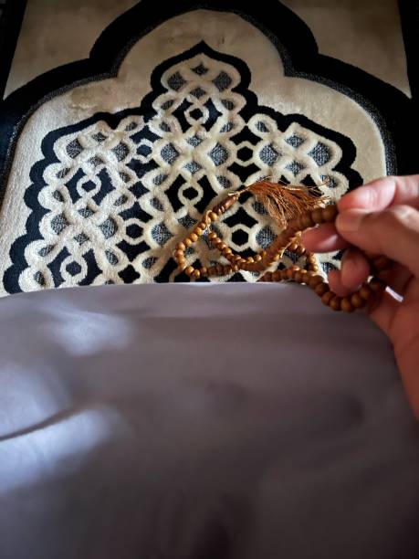 istock Hand woman holding rosary beads while wearing praying veil 2171132403