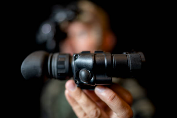 istock A special forces soldier iwith a night vision device in hand on a black background. 2171136529