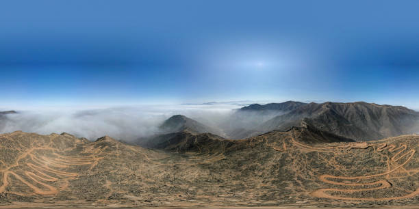 istock A panoramic shot of a mountain range with a cloudy sky in the background 2171138126