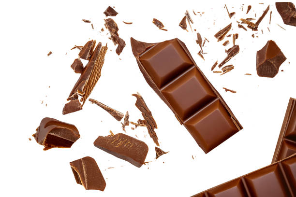 istock Isolated Chocolate bar pieces falling on white background. Milk Chocolate explosion with cocoa crumbs , curls and shavings, Top view. Flat lay. 2171142118