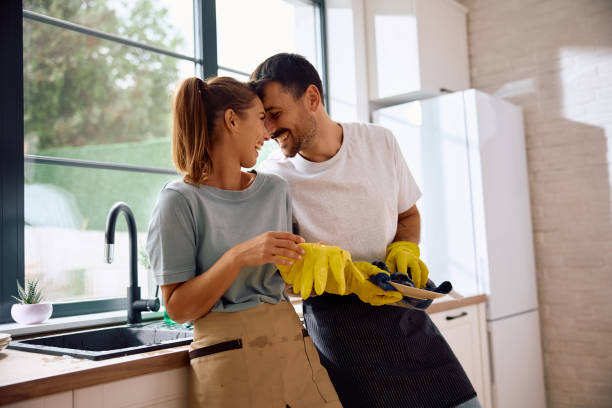 istock Affectionate couple doing the dishes in their kitchen. 2171142887