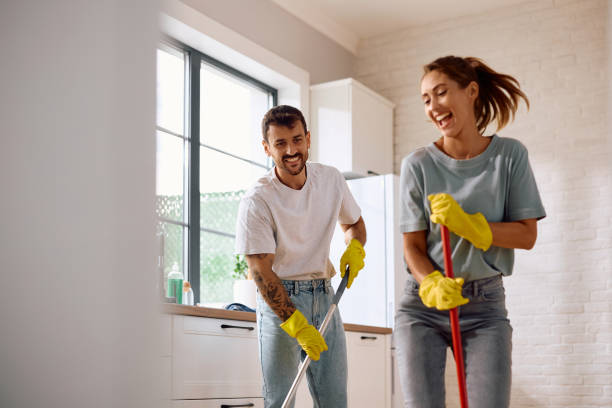 istock Cheerful couple cleaning their home together. 2171143102