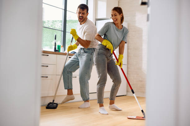 istock Carefree couple singing and dancing while cleaning their home. 2171143108