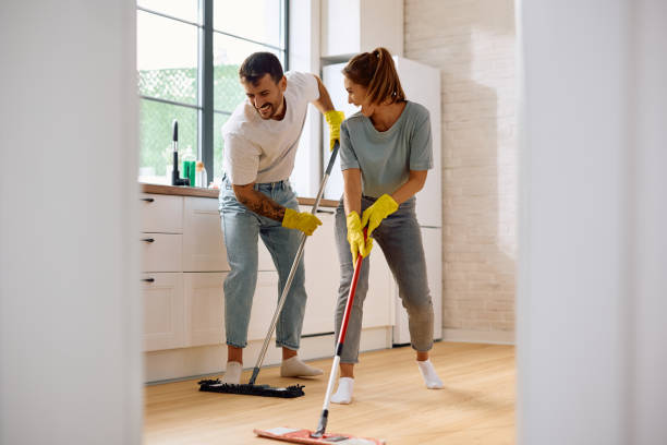 istock Happy couple cooperating while mopping the floor in the kitchen. 2171143141