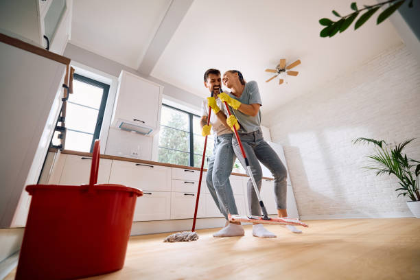 istock Cheerful couple singing while mopping the kitchen floor together. 2171143288