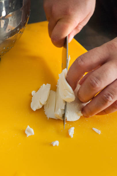 istock Pieces of buffalo mozzarella cheese sliced on a yellow board 2171144436