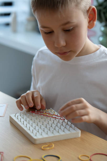 istock A Child Actively Engaged in a Fun Creative Rubber Band Art Activity Within His Home Environment 2171145279