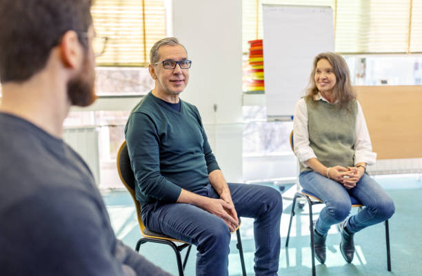 istock Senior man talking about emotions in a support group therapy session 2171148897