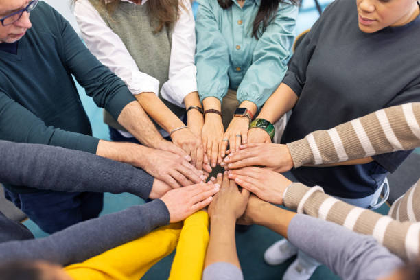 istock Group of people with hands together in a group therapy session 2171148903