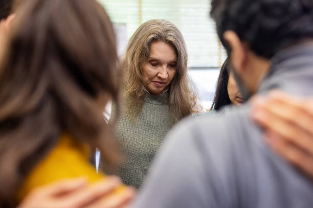 istock Multiracial group of people huddling in a support group meeting 2171148905