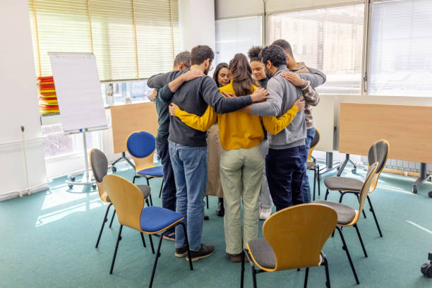 istock Diverse group huddling together in circle for support at community center 2171148924