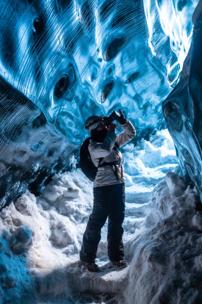 istock A person is taking a picture in a cave with a backpack on 2171152212
