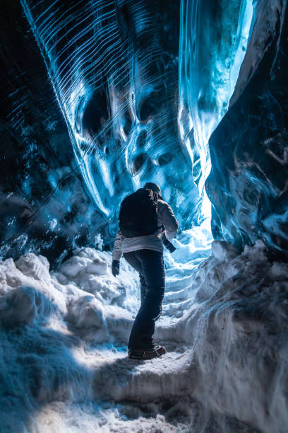 istock A person is walking through a cave with blue walls 2171152215