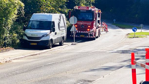 A team works on repairing a leaking underground water pipe along the roadside in Holte, a suburb of Copenhagen, Denmark. The photo was taken on September 16, 2024.