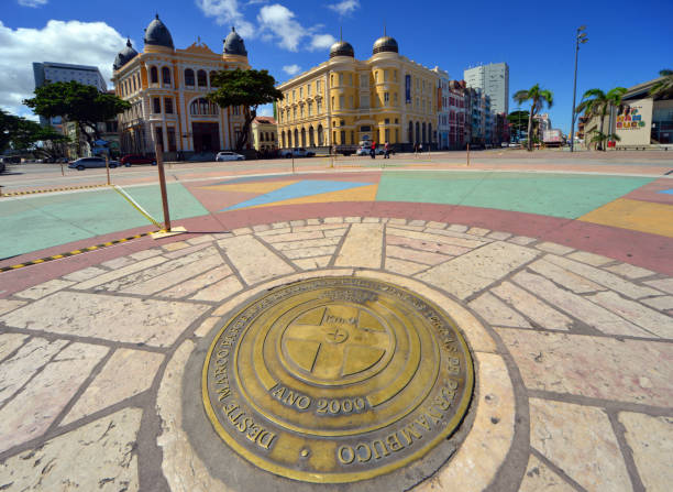 Recife, Pernambuco, Brazil: Marco Zero (zero mark), aka Baron of Rio Branco square is a historic square serving as the symbolic starting point for measuring distances within the state of Pernambuco. It marks the birthplace of the city, founded in 1537, and is a central hub for cultural and social activities. The square is surrounded by colorful colonial buildings and the Capibaribe River. On the left the Palace of Commerce and on the right the Caixa Cultural Recife, orginally the Bank of London & South America.
