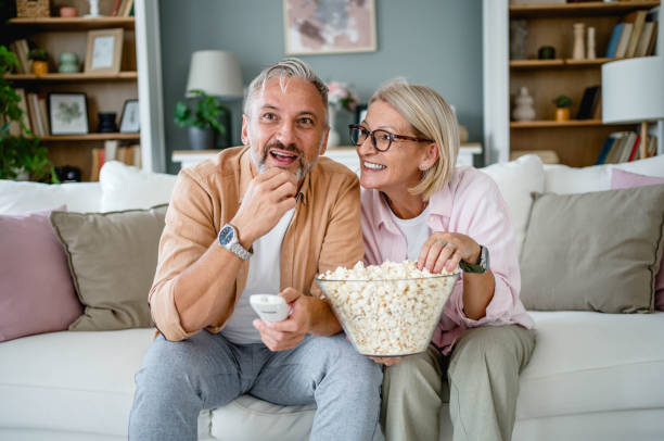 istock Mature couple watching tv at home 2171162745