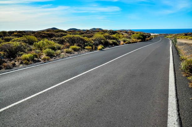 istock A long, empty road with a blue sky in the background 2171163751