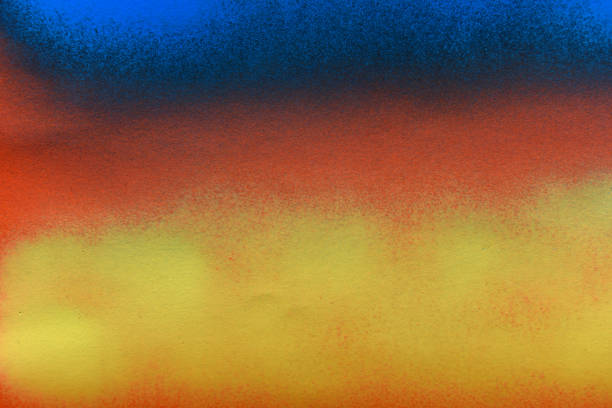 istock blue and yellow spray paint on orange paper background 2171164293