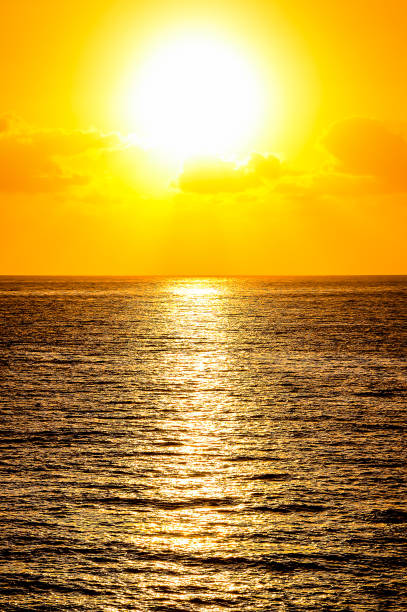 istock The sun is setting over the ocean, casting a warm glow on the water 2171164816