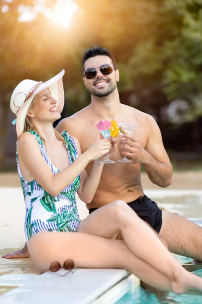 istock Two friends are toasting by the pool 2171165545