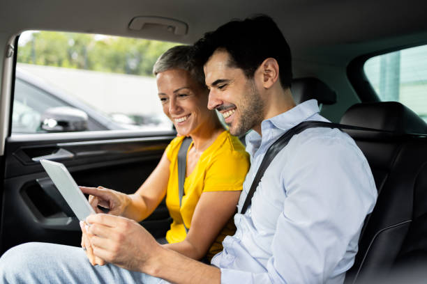 istock Couple traveling by a car and using tablet 2171168576