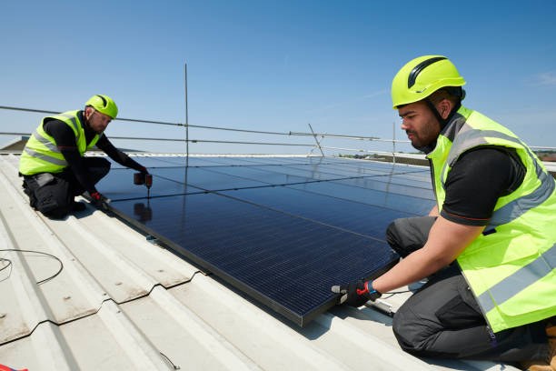 istock solar panels being fitted to factory roof 2171168630