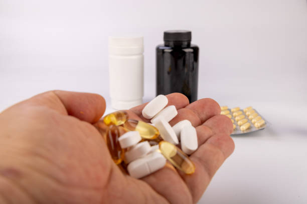 istock Hand with Different Medications and Medicine Bottles on Plain White Background 2171171310