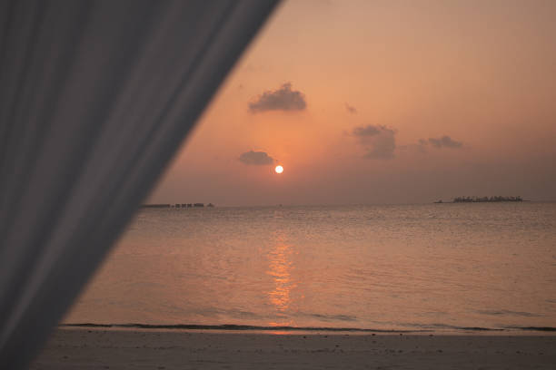 Golden sunset on the beach in the Maldives, calm.