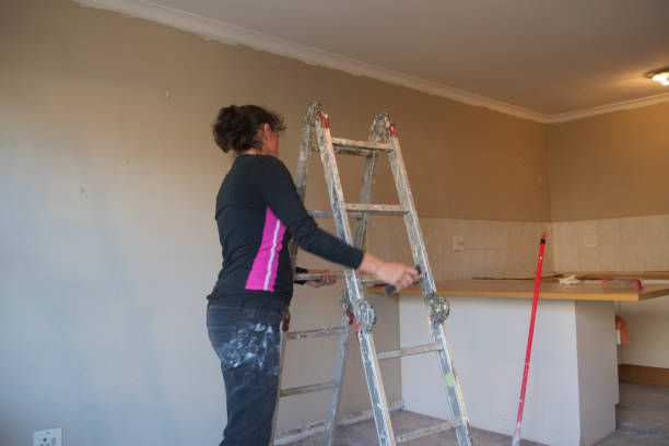 istock Woman moving a ladder while doing home improvements inside a apartment. 2171172553