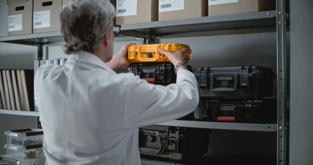 istock Mature scientist or archaeologist takes protective case from shelf 2171173459