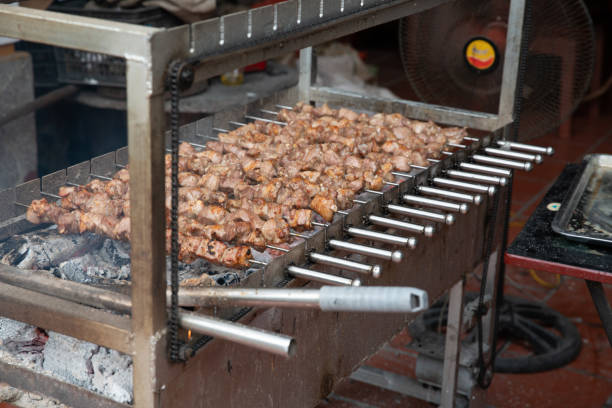 Meat cooking on a rotating grill.