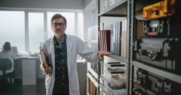 istock Portrait of mature scientist looking at camera while standing in archaeological laboratory 2171175135