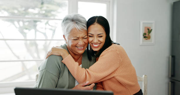 istock Senior woman, hug and laptop with support in home with tech learning and helping with internet banking. Family love, mom and embrace with smile, happy and care with planning and digital assistance 2171177421
